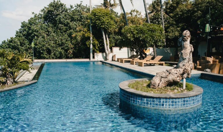 A serene poolside setting at a tropical luxury resort, perfect for relaxation.
