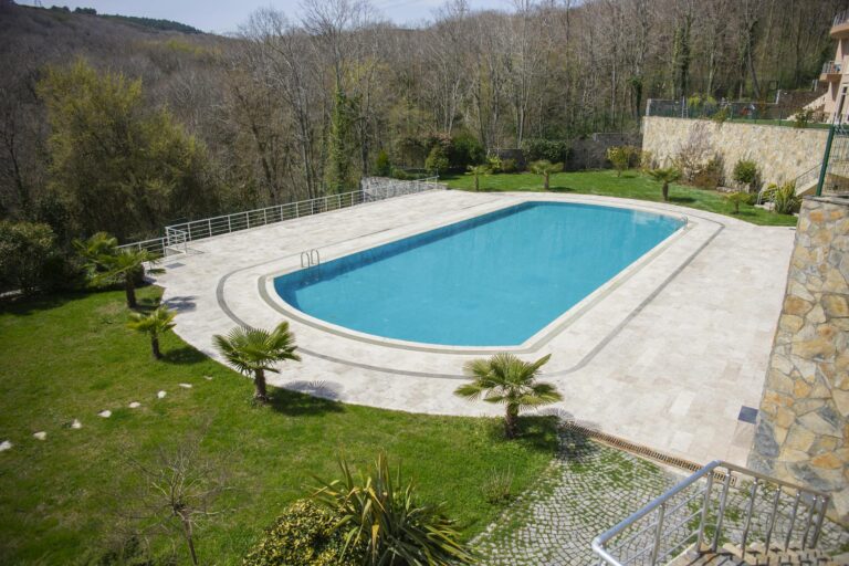 Discover tranquility by this outdoor swimming pool surrounded by lush greenery in Istanbul.