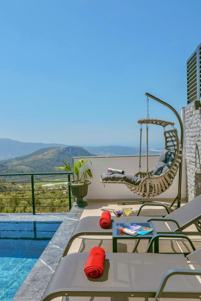 Relax by the pool in a luxury resort with stunning mountain views and cozy loungers.